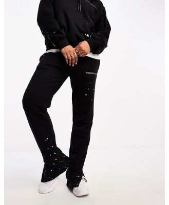 The Couture Club paint splatter straight leg trackies in black