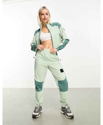 The North Face NSE woven shell trackies in sage green