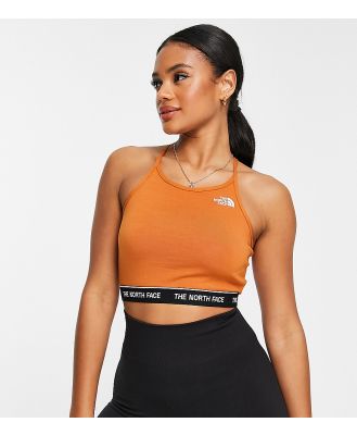 The North Face strap back crop top with logo hem in orange Exclusive at ASOS-Brown