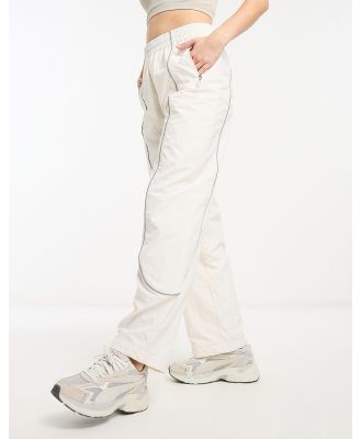 The North Face Tek woven track pants with reflective piping in cream-White