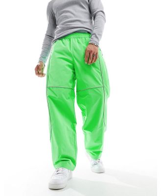 The North Face Tek woven trackies with reflective piping in bright green