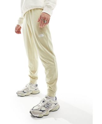 The North Face Training Reaxion logo trackies in beige heather-Neutral