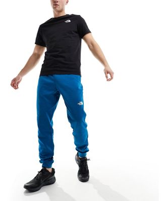 The North Face Training Reaxion logo trackies in blue heather