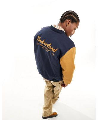 Timberland utility varsity bomber jacket with back print in navy with contrast sleeves