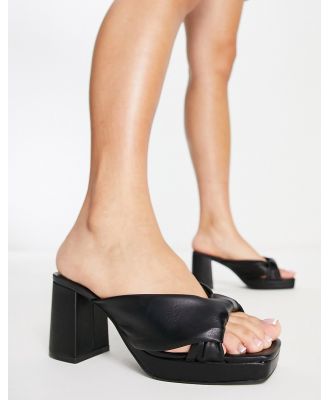 Truffle Collection block heeled cross front mules in black