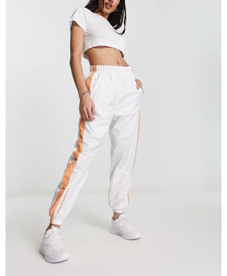 Under Armour Rush Woven pants in white and orange